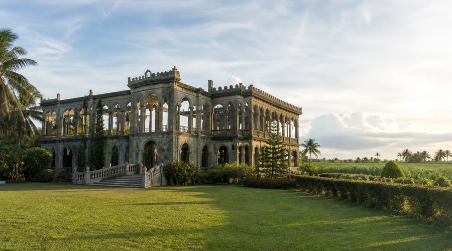 A colonial-era mansion ruin set among sugar-cane fields in Negros Occidental