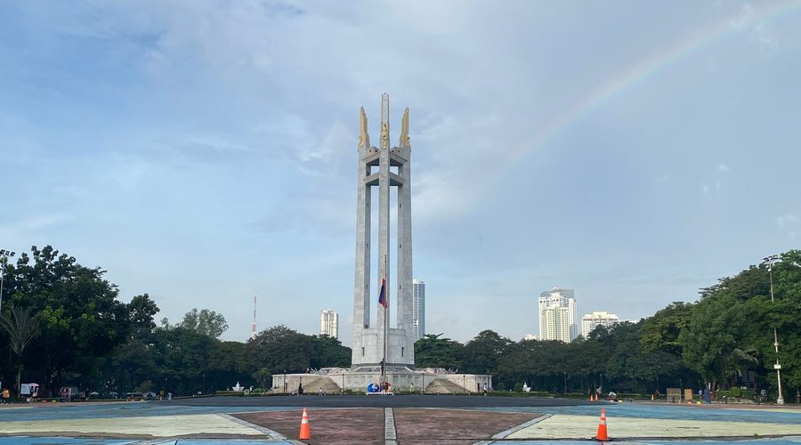 The three pylons of the Quezon Memorial Shrine at Quezon Memorial Circle, with the Quezon City skyline behind